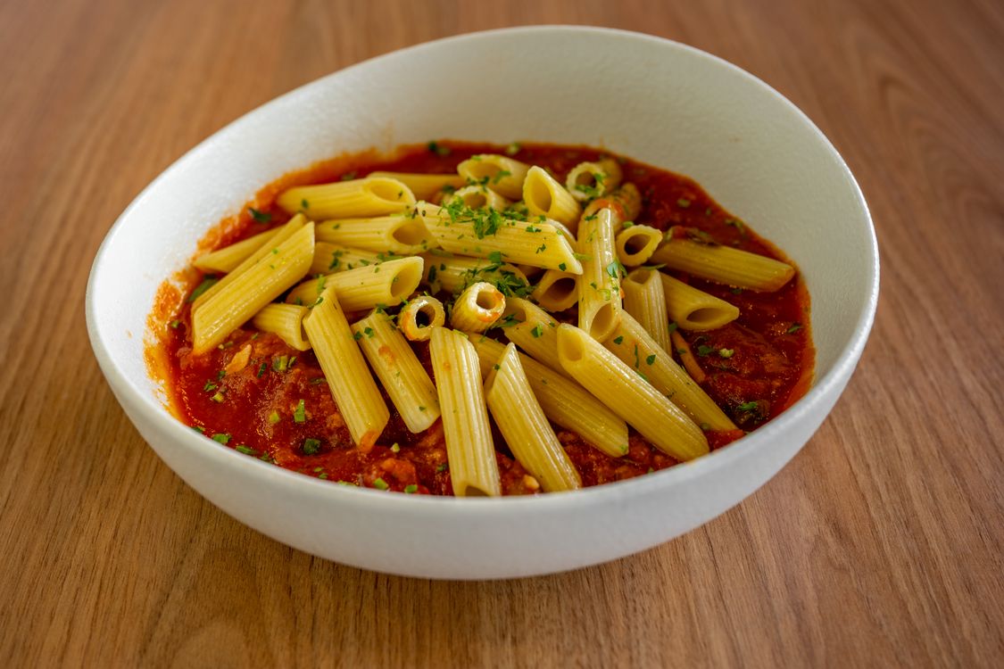Penne pasta in tomato sauce with herbs